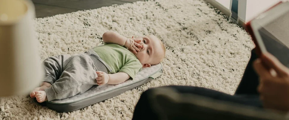 dad watching his child while using a device