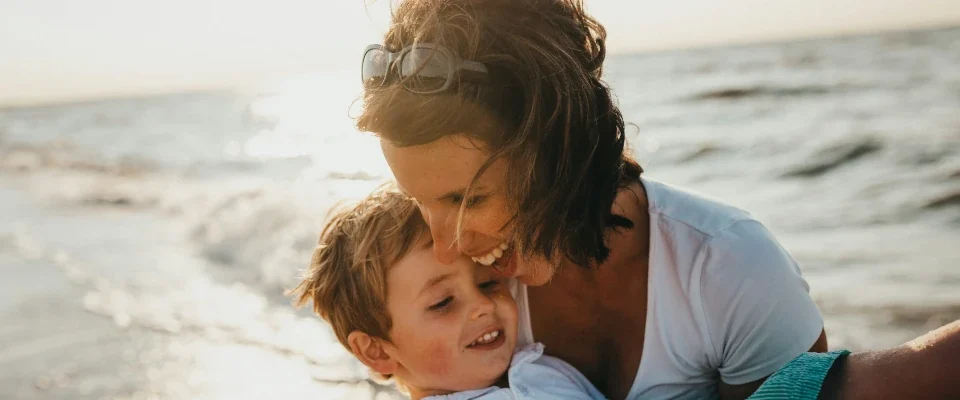 mother and child beside the sea