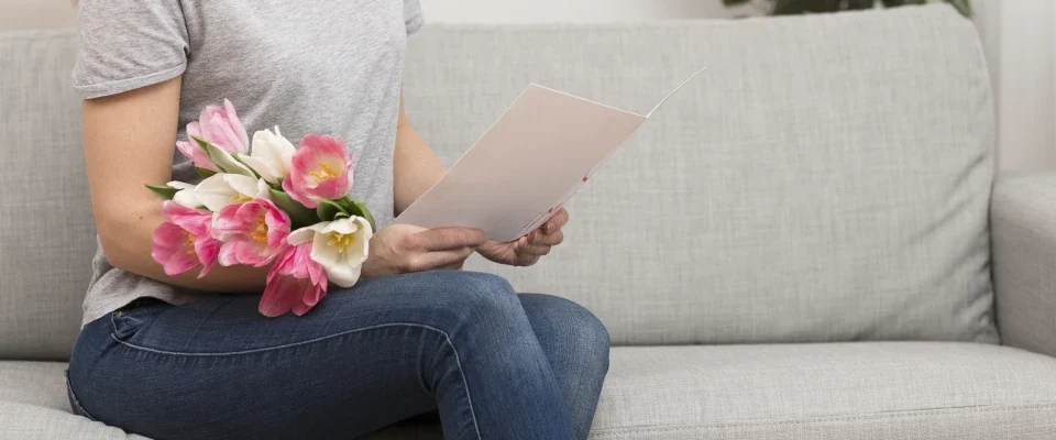 side view woman reading greeting card