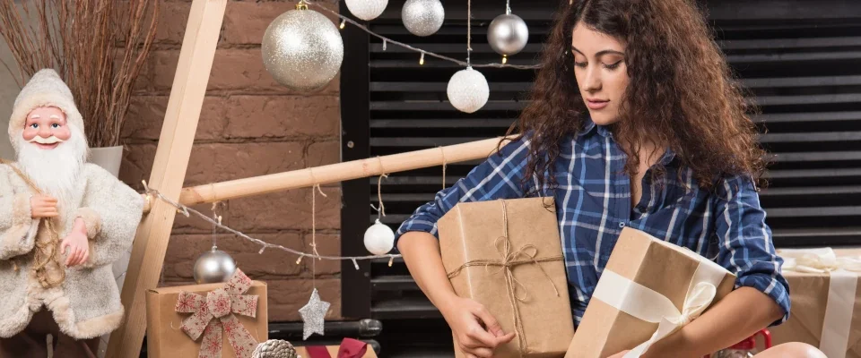 young woman sitting fluffy carpet with boxes christmas presents