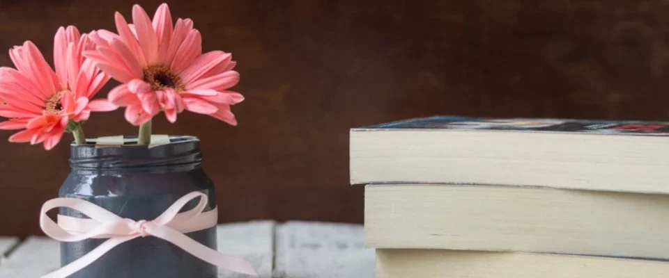 Background of table with books and flowers
