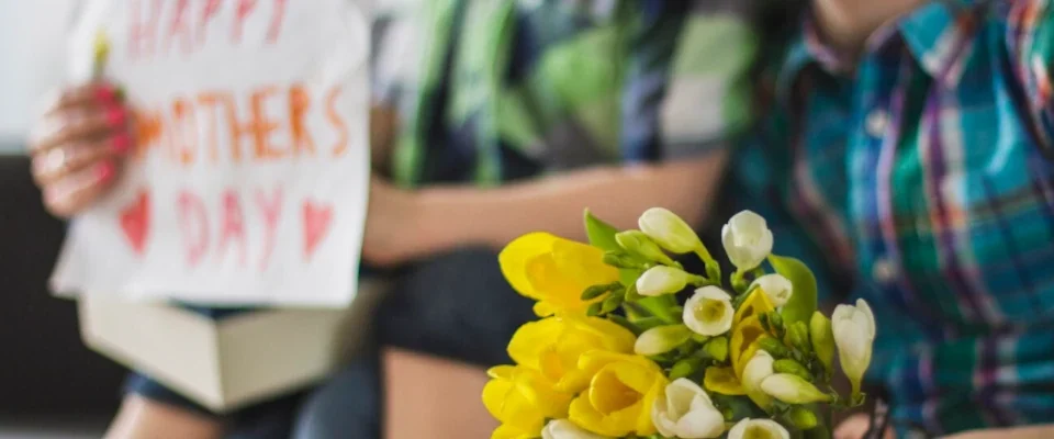 Close-up of boy with bouquet for his mother