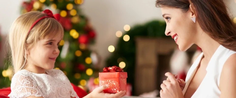 Daughter handing over gift for mummy
